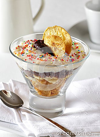 Sweet dessert made with cereals, banana, chocolate and cream. Stock Photo