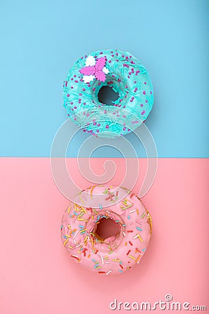 Sweet donuts, blue on pink, pink on blue. Concept conflict of contradictions, individuality in the generalization, the Stock Photo