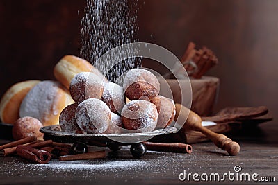 Sweet donuts with cinnamon sticks powdered with sugar. Stock Photo