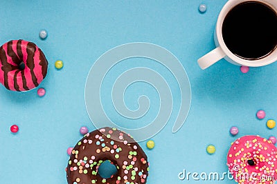 Sweet donuts with coffee on the blue background. Stock Photo