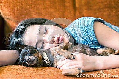 Sweet dream. Young girl sleeping hugging her lovely dog Stock Photo