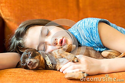 Sweet dream. Young girl sleeping hugging her lovely dog Stock Photo