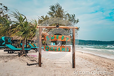 sweet dreams inscription on a wooden Board the name of the hotel and the beach on a tropical island.. Koh Rong Samloem, Saracen Editorial Stock Photo