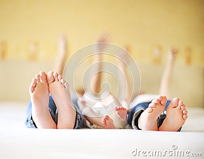 Sweet family in bed. Three sisters, close up on feet Stock Photo