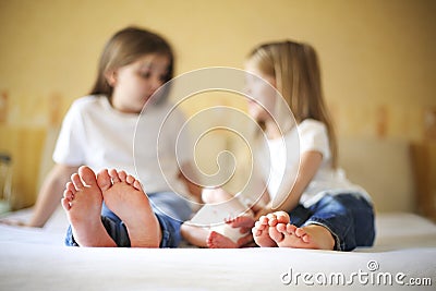 Sweet family in bed. Three sisters, close up on feet Stock Photo