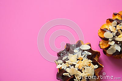 Sweet food with natural ingredients. Chocolate eclairs with almond slices. Stock Photo