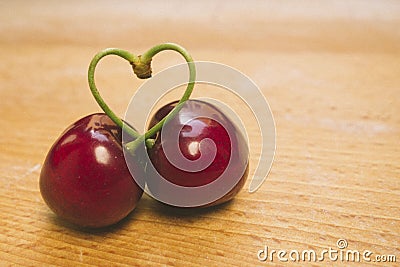 Sweet fresh cherries in film style with pies heart-shaped. Stock Photo