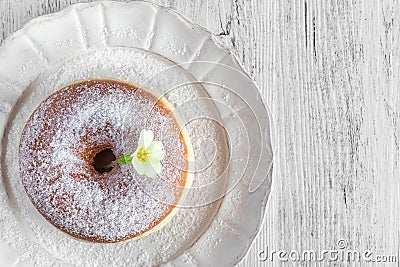 Sweet fried donut covered with sugar on plate Stock Photo