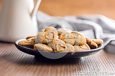 Sweet gingerbread hearts on plate Stock Photo