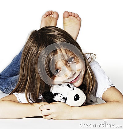 Sweet girl with puppy soft toy lying Stock Photo