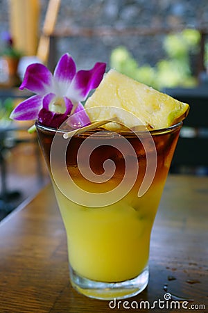 Sweet Hawaiian Mai Tai cocktail with an orchid flower Stock Photo