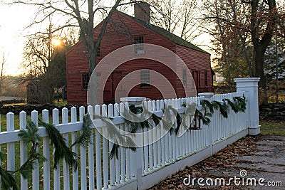 Long white picket fence with tree boughs for decoration, Genesee Country Village & Museum, Rochester, New York, 2017 Editorial Stock Photo