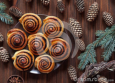 Sweet Homemade christmas baking. Cinnamon rolls buns with cocoa filling. Kanelbulle swedish dessert. Festive decoration. Stock Photo