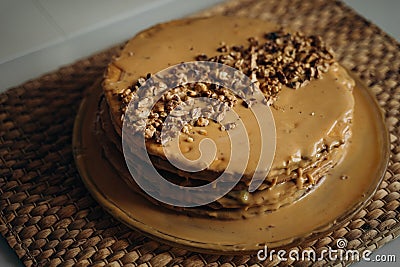 Sweet homemade honey cake with caramel topping and walnuts topping. Tasty brown cake dessert Stock Photo