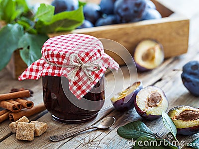 Sweet homemade plum jam and fruits on table. Stock Photo
