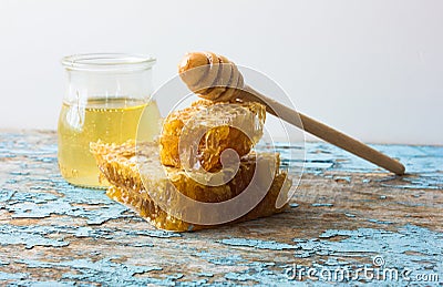 Sweet honey in the comb . On rural wooden background. Glass bank with honey Stock Photo