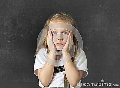 Sweet junior schoolgirl crying sad in children education stress and bullying victim Stock Photo