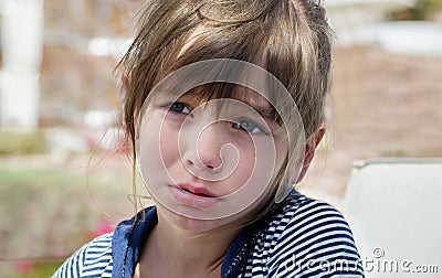 A sweet little girl pouted and cried, offended, a childish whim Stock Photo