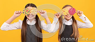 Sweet look. Funny pupils cover eyes with lollipops. School education. Always sweet life. Teenager child with sweets Stock Photo