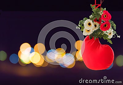 Sweet lovely background of red heart decorated with flower on bokeh light at night Stock Photo