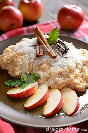 Sweet millet porridge with honey, apples and grated coconut Stock Photo