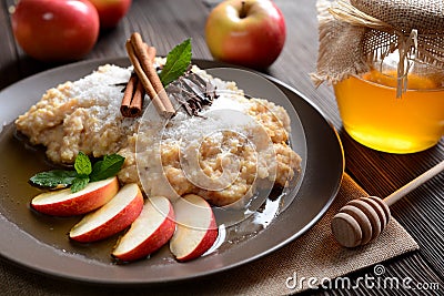 Sweet millet porridge with honey, apples and grated coconut Stock Photo