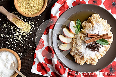 Sweet millet porridge with honey, apples and grated coconut Stock Photo