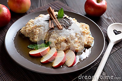 Sweet millet porridge with honey, apples and grated coconut Stock Photo