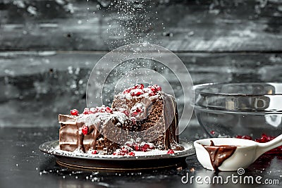 Sweet moments - sweet moments - brownies poured hot, liquid chocolate, sprinkled with red pomegranate seeds and powdered sugar Stock Photo