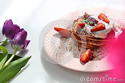 Sweet pancakes with strawberries, cottage cheese and colorful sugar sprinkles Stock Photo