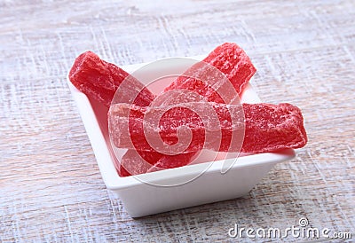 Sweet papaya dried slices in white plate on wood background. selective focus. Stock Photo