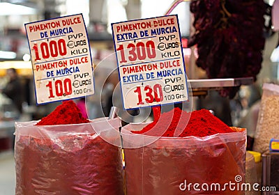 Sweet paprika powder in large plastic bags for sale in food market with price tags Stock Photo