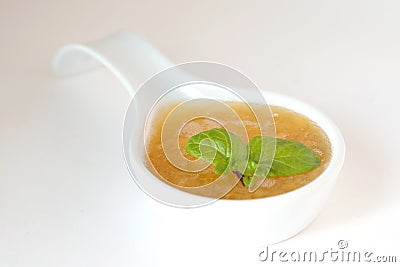 Sweet peach sauce decorated with mint Stock Photo