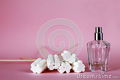 Sweet perfume bottle used almost empty on pink background. long shadows. copy space Stock Photo