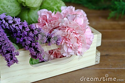 Sweet Pink and Purple Flowers on wood table Stock Photo