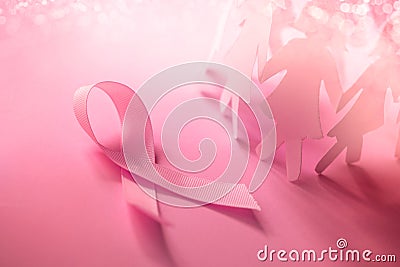 The Sweet pink ribbon shape with girl paper doll on pink background for Breast Cancer Awareness symbol to promote in october mo Stock Photo