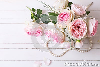 Sweet pink roses flowers on white painted wooden background. Stock Photo