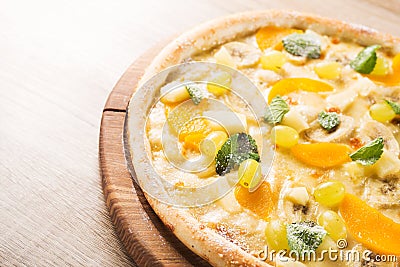 sweet pizza with banana, grapes and mint Stock Photo