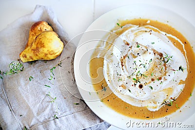 Sweet potato and rutabaga creamy soup with pears, herbs Stock Photo