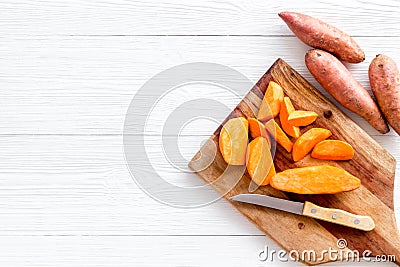 Sweet potato - sliced yams organic vegetables on cutting board, view from above Stock Photo