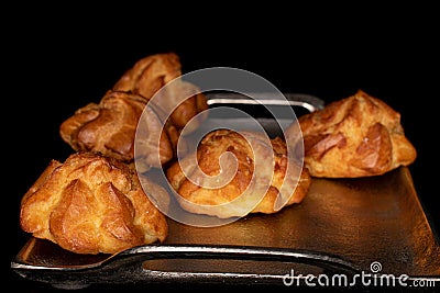 Sweet profiterole on black glass Stock Photo