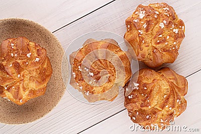 Sweet profiterole on white wood Stock Photo