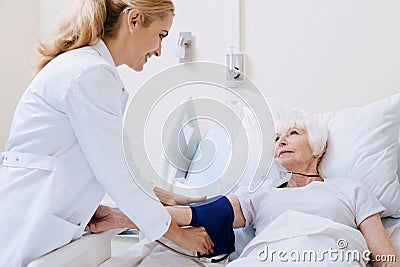 Sweet qualified doctor making some measurements Stock Photo