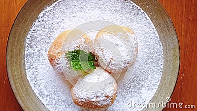 Sweet round bread with sugar powder on plate Stock Photo