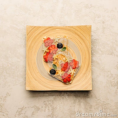 Sweet sandwiches peanut butter with fruits, berries with honey on a wooden board, top view. Stock Photo