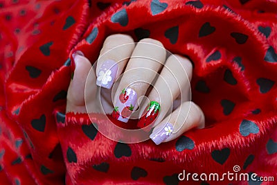 Sweet shiny baby purple and red gel polish painting cute white little flower and yummy strawberry on woman short square shape Stock Photo