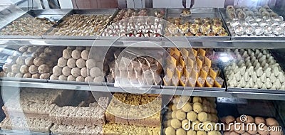 In India, bikaner sweets, shops, sweets, modak, pedhe, barfi, mawa barfi, glass, delicious sweets, people are very crowded to eat Stock Photo