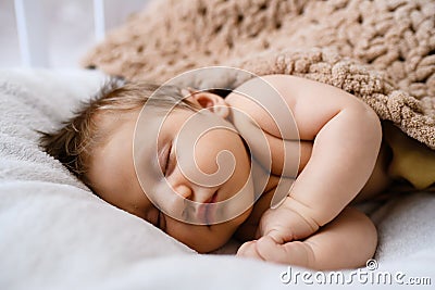 Portrait of sweet sleeping newborn baby in bed Stock Photo