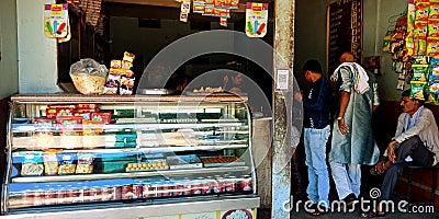 sweet and snacks shop, people entering for having something Editorial Stock Photo