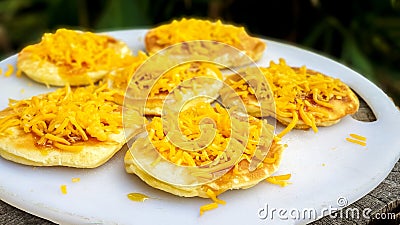 Sweet syrup / honey and salty cheese on round pancakes / flapjacks for breakfast or brunch. Stock Photo